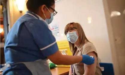  ??  ?? A health worker administer­s a vaccine dose in Hull, north-east England, last week. Photograph: Oli Scarff/AFP/Getty Images