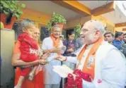  ?? PTI PHOTO ?? BJP president Amit Shah during his doortodoor campaign in Naranpura, Gujarat, on Tuesday.