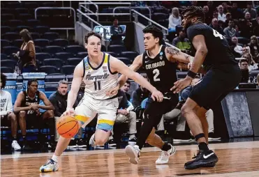  ?? Michael Conroy/associated Press ?? Tyler Kolek (11) had 21 points and 11 assists to help No. 2 seed Marquette hold off No. 10 seed Colorado 81-77.