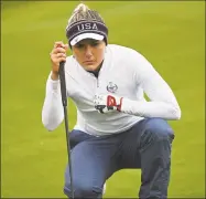  ?? Andy Buchanan / Getty Images ?? USA’s Lexi Thompson lines up her putt on the 18th green during the Solheim Cup on Saturday.