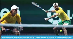  ?? — AFP ?? MALAGA: Australia’s Jordan Thompson (right) with Australia’s Max Purcell returns the ball during the men’s double semi-final tennis match between Croatia and Australia of the Davis Cup tennis tournament at the Martin Carpena sporthall in Malaga on November 25, 2022.