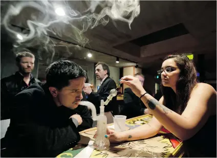  ?? TED S. WARREN/ THE ASSOCIATED PRESS FILES ?? A patron inhales marijuana vapour at a lounge in Tacoma in Washington, which along with Colorado, became the first U. S. states to legalize the drug. Studies in Canada have shown that 40 per cent of the population has used it at least once.