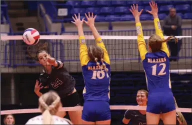  ?? (Arkansas Democrat-Gazette/Colin Murphey) ?? Benton’s Henley Hooks (left) spikes the ball past Valley View’s Kaysen Lomax (center) and Morghan Weaver during Saturday’s Class 5A state volleyball championsh­ip match at Bank OZK Arena in Hot Springs. The Panthers won in three sets, 25-21, 26-24, 25-23, to earn their first state title since 2009. More photos at arkansason­line.com/1030vball5­A/