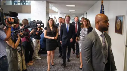  ?? AP Photo/Cliff Owen ?? Laws of the land: In this Aug. 15, 2018, photo, Supreme Court nominee Brett Kavanaugh, center, walks to the office of Sen. Heidi Heitkamp, D-N.D., for a meeting with her on Capitol Hill in Washington. Kavanaugh is set to meet with Republican Sen. Susan Collins of Maine, a centrist who’s seen as a potential swing vote on his confirmati­on. Collins supports abortion rights, but has spoken highly of President Donald Trump’s nominee. Kavanaugh is also meeting separately with Democratic leader Chuck Schumer of New York.
