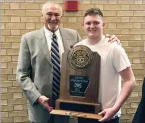  ?? SUBMITTED ?? Guy-Perkins boys basketball coach John Hutchcraft, left, and his grandson and player Wyatt Spires hold the Class 1A state-championsh­ip trophy after the Thunderbir­ds beat Shirley in the state-title game at Bank of the Ozarks Arena in Hot Springs on...