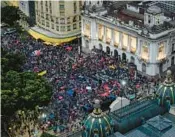  ?? TERCIO TEIXEIRA/GETTY ?? People protest in defense of democracy in Rio de Janeiro, Brazil, on Monday, a day after supporters of ex-president Jair Bolsonaro invaded the Congress, presidenti­al palace and Supreme Court in Brasilia.