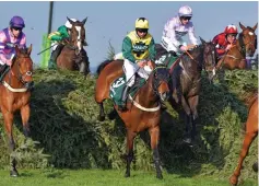  ?? FOCUS IMAGES ?? Five-star display: Frost (in yellow) on Milansbar clears the Chair fence