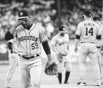  ?? Jeffrey McWhorter / Associated Press ?? Astros lefthander Framber Valdez, left, called up from the minors for a spot start, recorded only two outs and allowed four earned runs on four hits and three walks in the first inning.