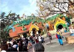  ??  ?? Visitors stand in line (also below) as they wait to see Mickey Mouse during an event commemorat­ing the birthday of the Disney character, in Tokyo Disneyland, Urayasu, Chiba Prefecture, Japan Sunday, in this picture obtained from social media. — Reuters photos