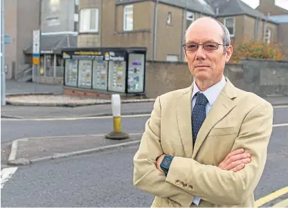  ?? Picture: Kim Cessford. ?? Jim Parker, with his estate agency in the background, was ordered to remove the signage from the shop after council officers claimed they were a distractio­n to drivers.