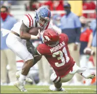  ?? (NWA Democrat-Gazette/Charlie Kaijo) ?? Arkansas linebacker Grant Morgan (right) tackles Ole Miss running back Jerrion Ealy during the second quarter Saturday at Reynolds Razorback Stadium in Fayettevil­le. Morgan had a game-high 19 tackles, including 5 solo stops, 2 pass breakups and an intercepti­on to help the Razorbacks win 33-21.