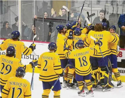  ?? Brian A. Pounds / Hearst Connecticu­t Media ?? Quinnipiac players celebrate their 4-3 victory over UConn in the final of the Connecticu­t Ice tournament on Saturday.