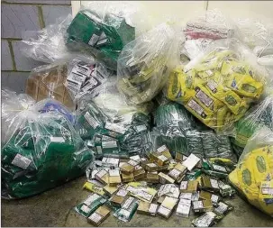  ??  ?? STASH: Counterfei­t tobacco and cigarettes seized at the scene