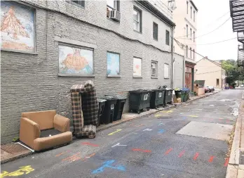  ?? CHRISTINA TATU/THE MORNING CALL ?? Dumpsters and garbage line Sitgreaves Street in Easton. A group of local business owners want to see it cleaned up.