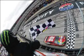  ?? ROBERT LABERGE / GETTY IMAGES ?? Kyle Busch takes the checkered flag to win the rain-delayed NASCAR Cup Series Food City 500 at Bristol Motor Speedway on Monday.