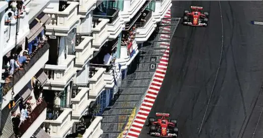  ??  ?? Einzigarti­ge Kulisse: In den engen Häuserschl­uchten von Monte Carlo führen die Ferraripil­oten Kimi Raikkonen (unten) und Sebastian Vettel nach dem Beginn des Rennens das Feld an. Foto: Mark Thompson, Getty