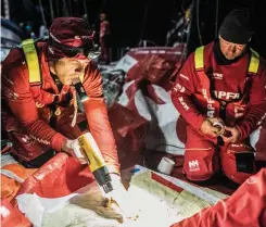  ?? PHOTO: UGO FONO L LA/ VOLVO OCEAN RACE ?? Mapfre’s Antonio Cuervas-mons warms the glue for a sail patch as the team stops to repair its mainsail and mast track.