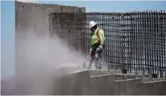  ??  ?? BOULDER CITY: In this May 19, 2017 photo, a man works on the Southern Nevada portion of US Interstate 11 near Boulder City, Nevada. President Donald Trump is planning a major push next week to promote a $1 trillion rebuilding of the nation’s roads and...