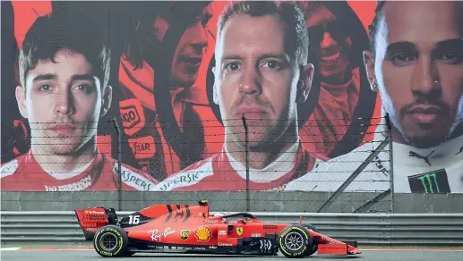  ?? (Afp) ?? Gigantogra­fie Charles Leclerc, 21 anni, guida la sua Ferrari nelle prove libere sul circuito di Shanghai passando davanti alla sua foto e a quelle di Vettel e Hamilton
