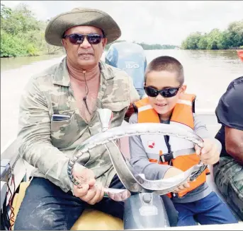  ??  ?? Essequibo Chamber President Roopan Ramotar with his son Roopan (Jr.) on the Capoey Lake