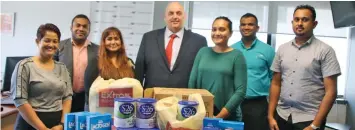  ?? Authority chief executive officer Jonathan Moore during the handover. ?? Founder and executive director of Aspire Network Karishma Kaajol Kumar (third from left) with Fiji Roads