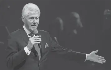  ?? TIMOTHY A. CLARY, AFP/ GETTY IMAGES ?? Former president Bill Clinton, at a fundraiser for his wife, profited from speeches and other appearance­s set up by Foundation aides.