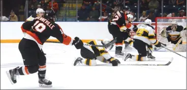  ?? NEWS PHOTO RYAN MCCRACKEN ?? Medicine Hat Tigers defenceman David Quennevill­e fires a shot through traffic during a Western Hockey League game against the Brandon Wheat Kings on Dec. 2, 2017 at the Canalta Centre.