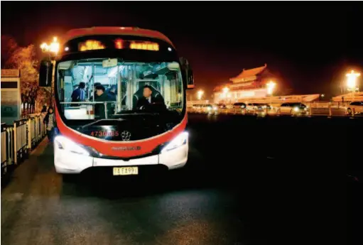  ??  ?? The Route 1 bus running through Chang’an Avenue has become another sightseein­g item at Tian’anmen Square in Beijing. by Ren Chao/xinhua