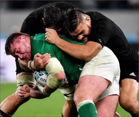  ??  ?? Tadhg Furlong is tackled by Samuel Whitelock and Angus Ta’avao of New Zealand.