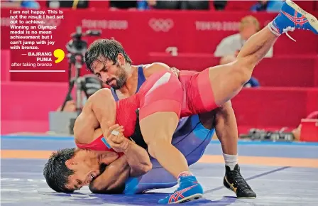  ?? — AP ?? India’s Bajrang Punia (top) competes against Daulet Niyazbekov of Kazakhstan during their men’s freestyle 65kg wrestling bronze medal match in Chiba, Japan, on Saturday. Bajrang won the bout 8-0.