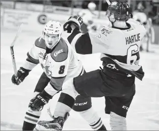  ?? Herald photo by Ian Martens ?? Lethbridge Hurricanes’ Taylor Ross knocks back Brandon Wheat Kings’ Chase Hartje during Game 1 of second round WHL playoff action Friday night at the Enmax Centre. @IMartensHe­rald