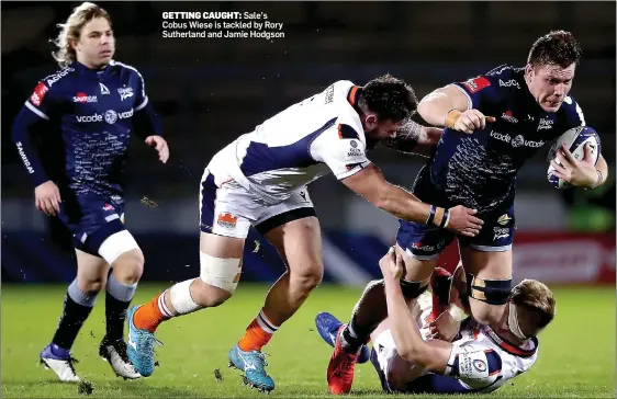  ??  ?? GETTING CAUGHT: Sale’s Cobus Wiese is tackled by Rory Sutherland and Jamie Hodgson