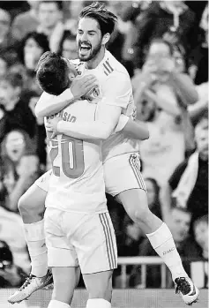  ??  ?? Real Madrid’s Spanish midfielder Marco Asensio (left) celebrates with midfielder Isco after scoring a goal a goal during the Spanish league football match against Eibar at the Santiago Bernabeu stadium in Madrid. — AFP photo