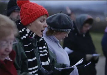  ??  ?? Marian Growney singing as the sun rises at the Easter Dawn ecumenical service on Bray Head.