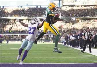  ?? Tom Pennington / Getty Images ?? Green Bay’s Davante Adams grabs a 12-yard touchdown pass over Dallas’ Jourdan Lewis with 11 seconds remaining in a game won in similar fashion to last season’s divisional playoff contest.