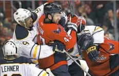  ?? Patrick Smith/Getty Images ?? Washington Capitals winger Tom Wilson and Buffalo Sabres winger Evander Kane push and shove in the second period Monday in Washington.