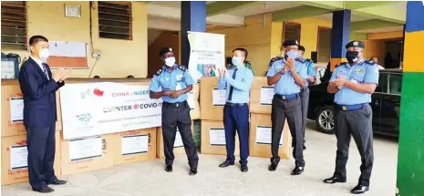  ??  ?? Officials of the Chinese Chamber of Commerce making a donation of COVID-19 protection equipment to the Nigeria Police in Abuja recently