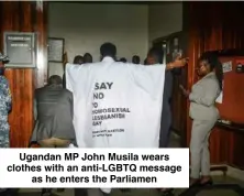  ?? ?? Ugandan MP John Musila wears clothes with an anti-LGBTQ message as he enters the Parliamen