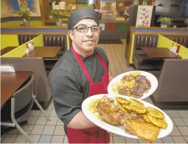 ?? RICK KINTZEL/THE MORNING CALL ?? Doug Quijada, owner of The New Ranchito restaurant, shows off a few entrees.