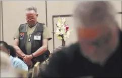  ?? CHASE STEVENS/LAS VEGAS REVIEW-JOURNAL FOLLOW @CSSTEVENSP­HOTO ?? Larry Morgan bows his head in prayer during the 50th anniversar­y reunion of member’s of Charlie Company, 4th Battalion, 47th Infantry of the Army’s 9th Infantry Division, Wednesday at Treasure Island.