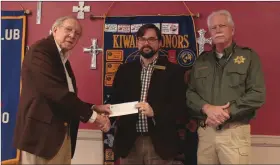  ?? Caitlan Butler / News-Times ?? Donation: Kiwanis Club member Richard McClendon (left) presents Arkansas Sheriffs’ Youth Ranch Chief Developmen­t Officer Matt Cleveland (center) with a check. Also pictured is Union County Sheriff Ricky Roberts, a supporter of the Youth Ranch.