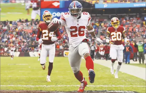  ?? Patrick Smith / Getty Images ?? Running back Saquon Barkley of the New York Giants rushes for a 78-yard touchdown in the second quarter against the Washington Redskins at FedExField on Sunday in Landover, Md. The Giants won 40-16.