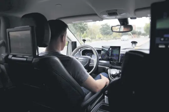  ??  ?? Waymo Trained Driver Derek Sirakis looks forward as the car drives during a demonstrat­ion in Chandler, Arizona, Nov. 29.