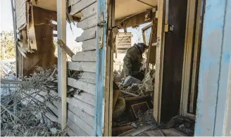  ?? BADERKHAN AHMAD/AP ?? A man on Sunday inspects a site in northeast Syria near where some Turkish airstrikes landed.