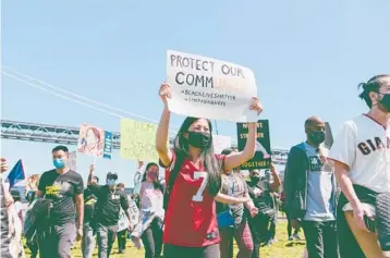  ?? MARISSA LESHNOV/THE NEW YORK TIMES ?? A rally organized by Black and Asian activists gathers in May in San Francisco.