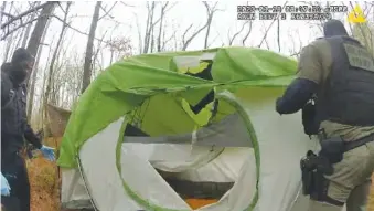  ?? ATLANTA POLICE DEPARTMENT VIA AP ?? In this image taken from body cam video officers remove and shred items from empty tent Jan. 18 near the future site of the City of Atlanta's Public Safety Training Center near Atlanta.