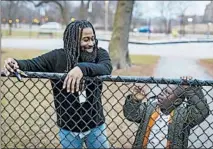  ??  ?? Friends of the Children mentor Keenan Palmer talks to Willie, 7, on the playground after school on Jan. 2 in Douglas Park.