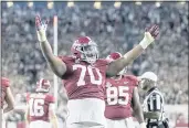  ?? VASHA HUNT — THE ASSOCIATED PRESS ?? Alabama offensive lineman Javion Cohen (70) signals a touchdown after a dive into the end zone by quarterbac­k Bryce Young during the second half Saturday against Tennessee in Tuscaloosa, Ala.