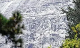  ?? KENT D. JOHNSON / KDJOHNSON@AJC.COM 2016 ?? Despite its past and Confederat­e legacy, Stone Mountain remains a popular site for African-American family reunions and where members of the community go to relax and exercise. The mountain, adorned with a huge carving of Confederat­e heroes, is...