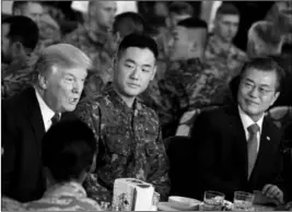  ?? ASSOCIATED PRESS ?? U.S. PRESIDENT DONALD TRUMP AND SOUTH KOREAN President Moon Jae-in (right) have lunch with U.S. and South Korean troops at Camp Humphreys in Pyeongtaek, South Korea, on Tuesday. Trump is on a five-country trip through Asia traveling to Japan, South...